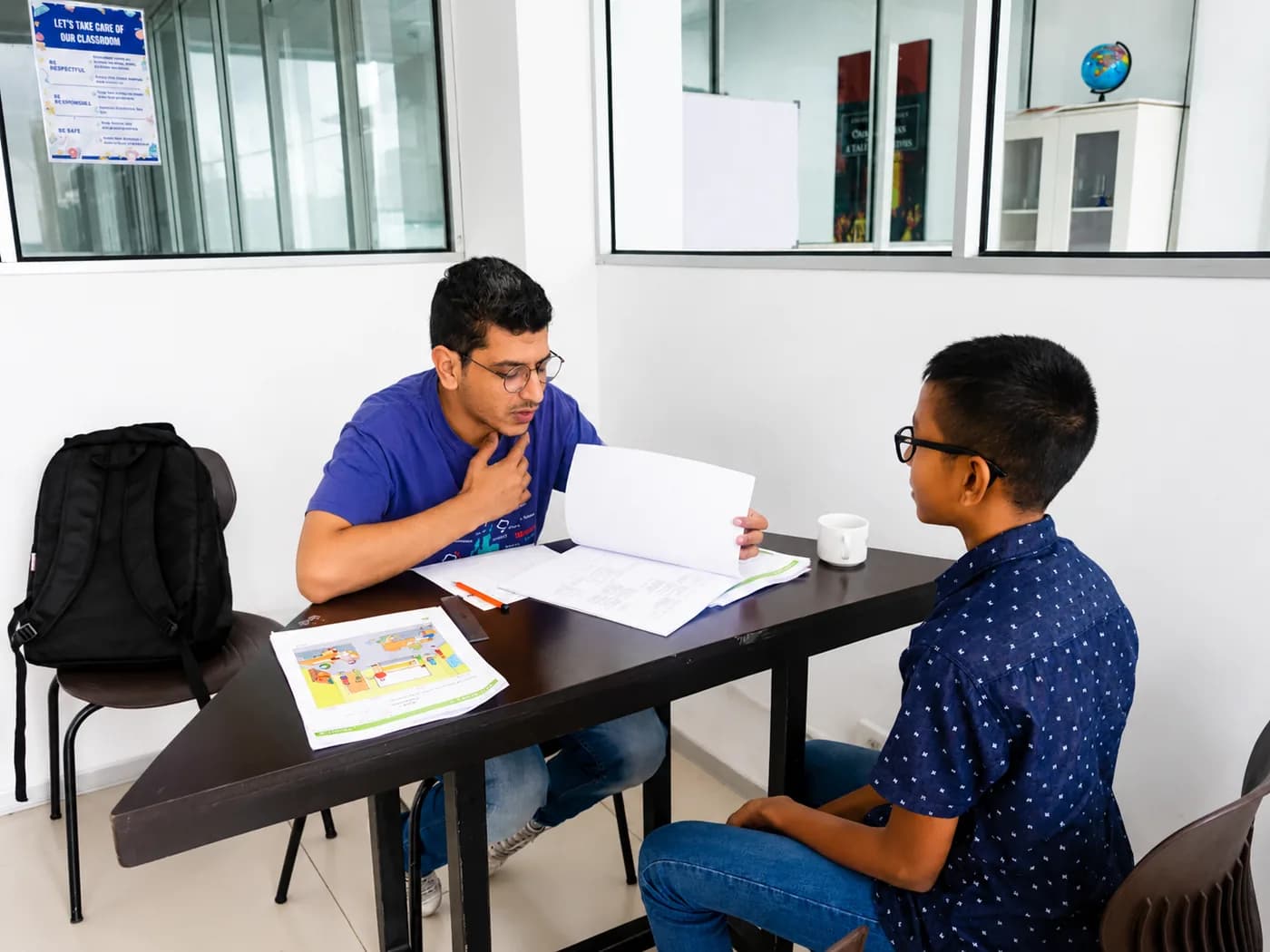 Teacher giving focused extra support to a student at ESOL College International